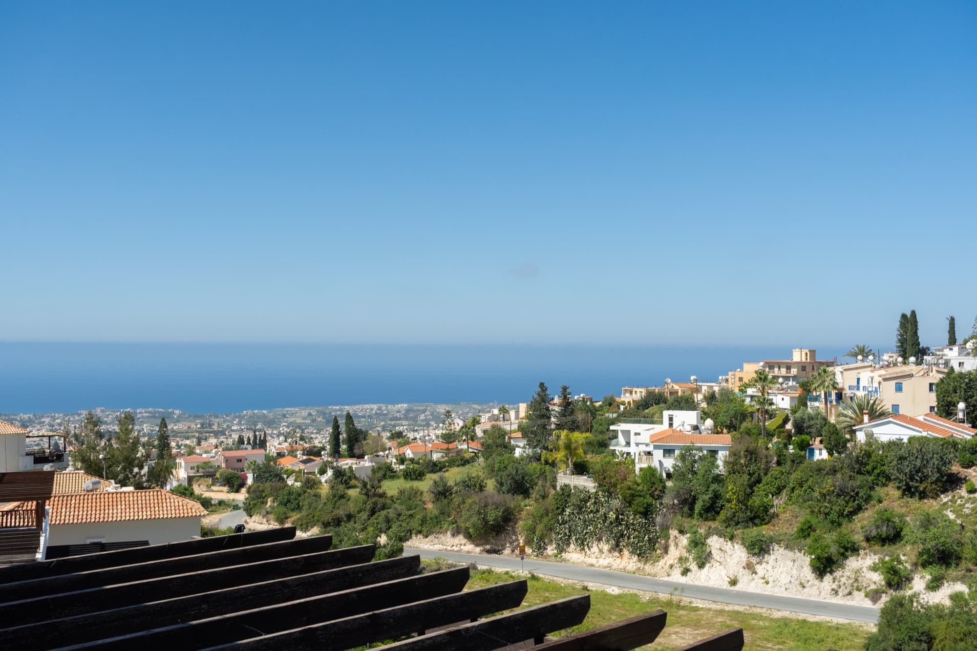 Sweeping sea view from the private terrace, looking out across Peyia village to the Mediterranean horizon